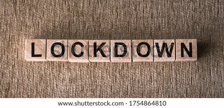 wooden blocks has text Lockdown on wooden background. Concept Lockdown covid-19