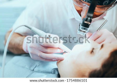 Stages of depulpation - the dentist cleans the dental canal and cauterizes the dental nerve Royalty-Free Stock Photo #1754886101