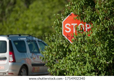
stop sign is installed out of the reach of drivers