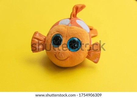 fish of yellow color on orange background
