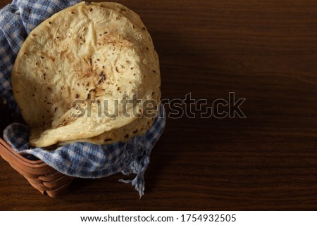 Corn tortilla in basket with checkered tablecloth, delicious Latin American vegan food
