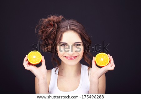 Cheerful young woman with citrus.