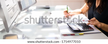 Chartered Accountant Hand Calculating Tax And Salary Royalty-Free Stock Photo #1754977010