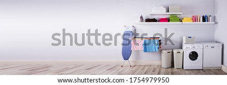 Utility Laundry Room Wall With Washing Machine Royalty-Free Stock Photo #1754979950