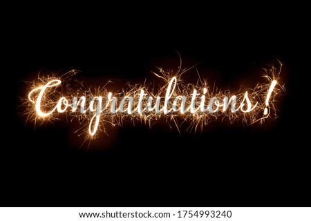 Congratulations banner text in dazzling sparkler effect on dark background Royalty-Free Stock Photo #1754993240
