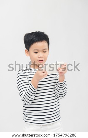 Happiness asian kid playing on smart phone