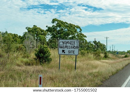 Vehicle Inspection Site highway sign with directional arrow