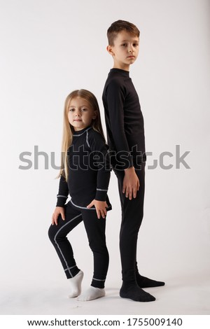 Boy and little girl in thermal underwear on a white background. Sportswear.