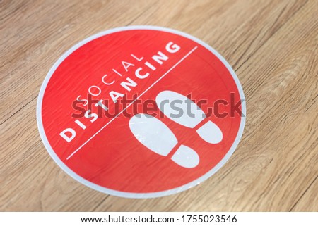 Footprint sign for stand in the mall.Social Distance word sticker poster.Social Distancing 6 Ft. Instruction against the Spread.New normal Reopen Mall.Social distancing in the workplace during covid19