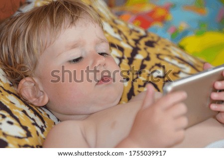 caucasian baby using cell phone