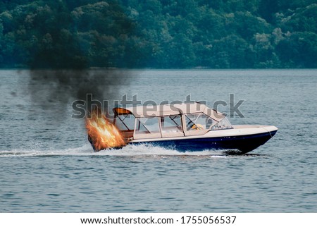 The boat's engine caught fire. Motor boat used for tourist tours Royalty-Free Stock Photo #1755056537