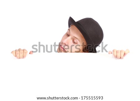 Young teenage boy hiding behind a billboard and looking down isolated on white background