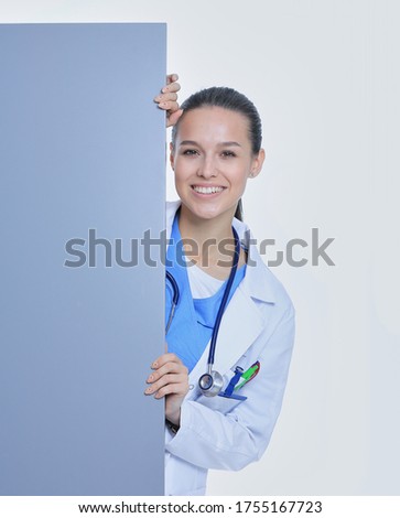A female doctor with a blank billboard. Woman doctor