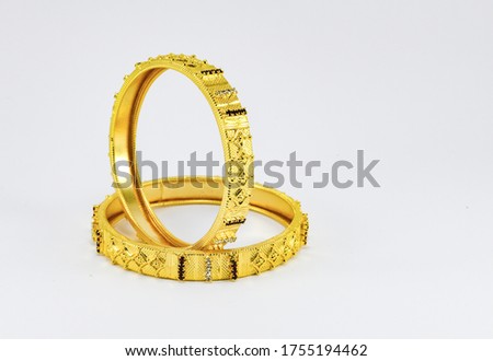 Beautiful golden bangles isolated on white background Royalty-Free Stock Photo #1755194462