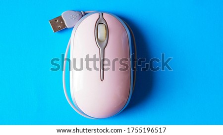 computer mouse pink on a blue background
