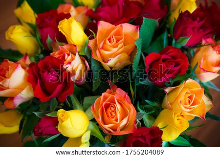 A bouquet of roses made of red, yellow and orange roses