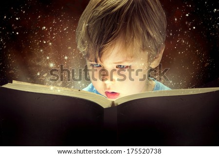 Child opened a magic book Royalty-Free Stock Photo #175520738