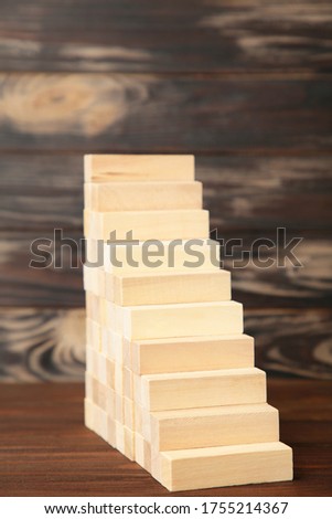 Wood block stacking as step stair with. Business concept for growth success process. Blocks on brown background