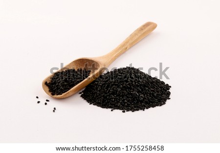 Black seed on a piece of burlap and wooden spoon isolated on white background Royalty-Free Stock Photo #1755258458