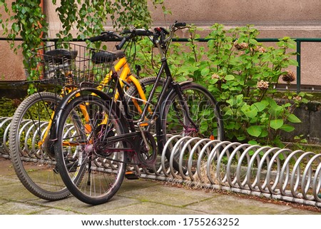 Modern Parking lot with Bicycles near an apartment red brick building with large number of bicycles. Eco-friendly and sports transport in the city. Royalty-Free Stock Photo #1755263252