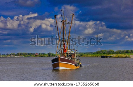 a crab cutter goes back to the port of greetsiel Royalty-Free Stock Photo #1755265868