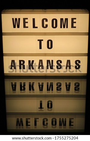 Old illuminated sign Welcome in Arkansas, USA