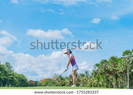 Style. Girl playing golf game on green grass.Fairway