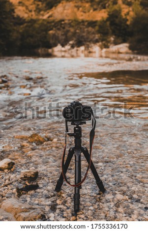 Camera standing in the river