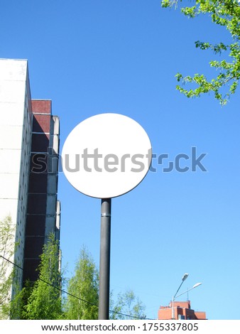 round white sign with a place to write on the background of a building in the city