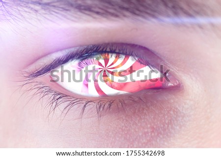 hypnotic eye effect, the macro view of the addicted person with spinned lines in eye