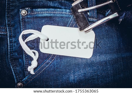 White paper card on deep blue jeans pocket. Father Day concept. Greeting card on a jeans background and space for text. For Father's Day or Birthday.