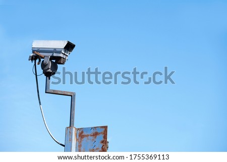 CCTV camera in sky watching people on street