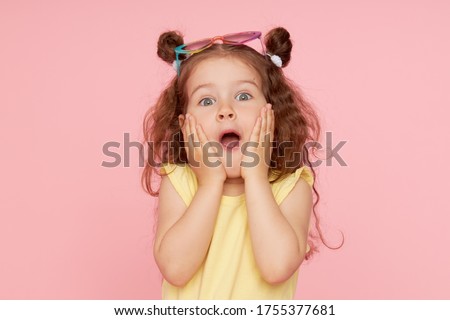 Portrait of a happy child. Cute little girl with a funny face on a pink background. Advertising baby products Royalty-Free Stock Photo #1755377681