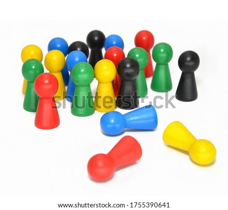 colored wooden gameboard pawns on white background