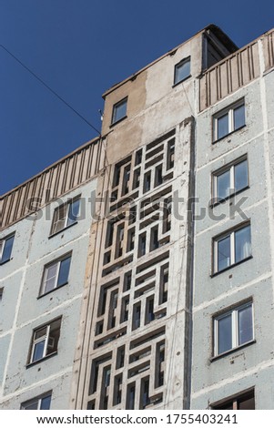 Old building of the twentieth century in the Russian city. The architecture of residential buildings in a minimalist style. A warm sunny day - a walk around the city.