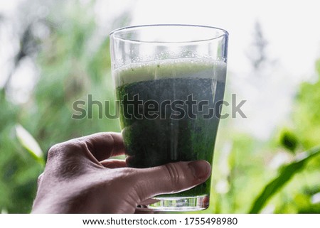Picture of green smoothie taken against the light.