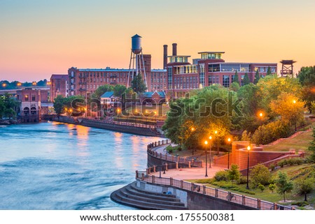 Columbus, Georgia, USA downtown skyline on the Chattahoochee River at dusk.