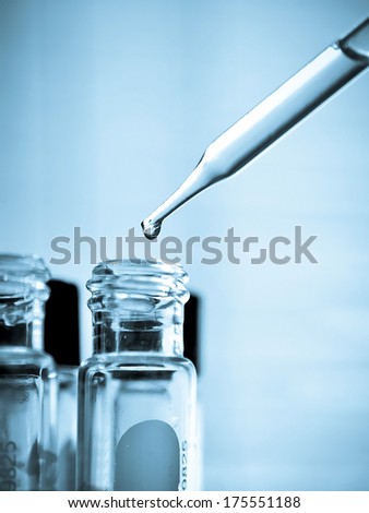Laboratory research, dropping liquid to test tube Royalty-Free Stock Photo #175551188