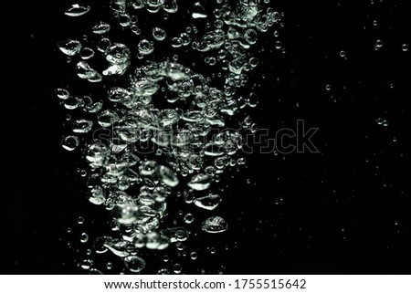 bubbles splash in water in high speed with black background