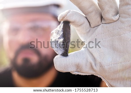 rough ore stone, palladium nugget. Concept of metal mining used in the industry. Spot focus Royalty-Free Stock Photo #1755528713