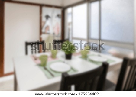 Blurred photo of house dining room with bright light