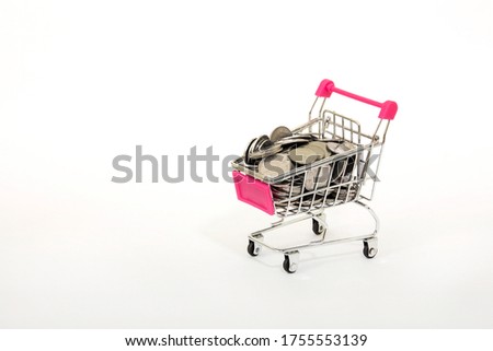 Shopping cart full of coins over the white background
