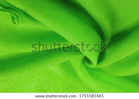 Texture. Background fabric of silk green matte color, (paint or surface) is dull and flat, without shine.