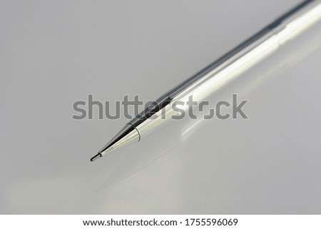 A silver chrome pencil isolated on white background with empty space for mockup design.