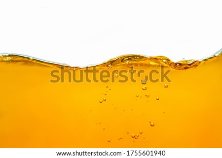 Closeup process of splashing of green tea. Macro shot of liquid in transparent glass. Abstract background with splashes, sprays, waves, bubbles of lager beer, whiskey, cognac, rum, brandy.  Royalty-Free Stock Photo #1755601940