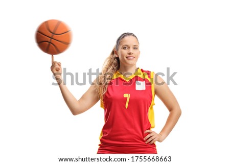 Woman basketball player spinning a ball with a finger isolated on white background
