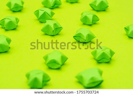 Solid green background with paper stars in a children's style. Template for scrapbooking.