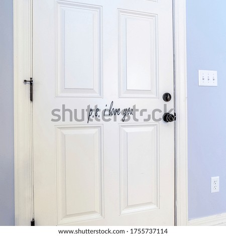 Square White interior wooden door in a blue wall