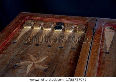 Backgammon Pieces Showing Black Pieces Inside A White Army