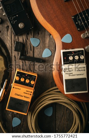 Sound gear for guitarists on wooden background